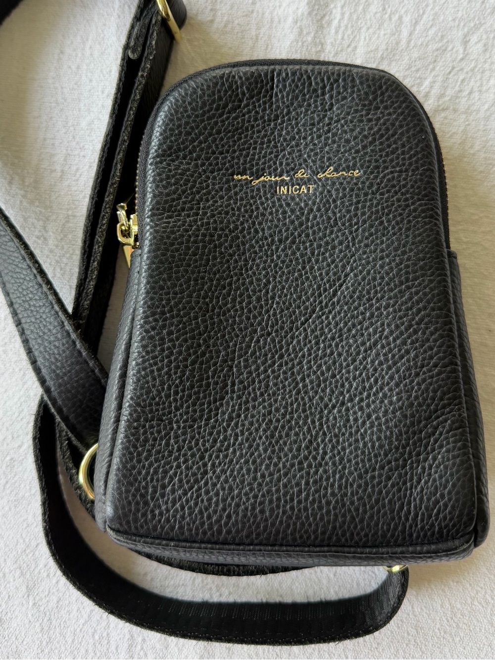 INICAT Black Pebbled Leather Crossbody Bag with Gold Script